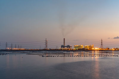 View of bridge over river at sunset