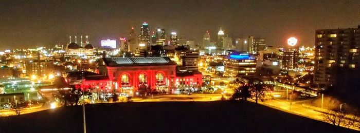 High angle view of city lit up at night