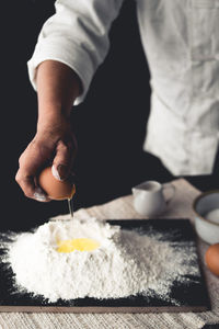 Close-up of person preparing food on table