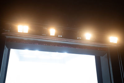 Low angle view of illuminated bridge against sky at night