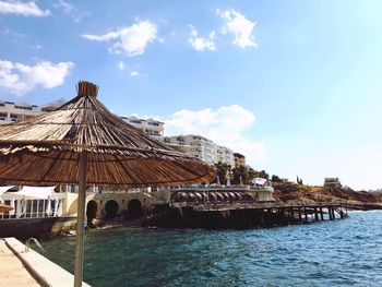 Building by sea against sky