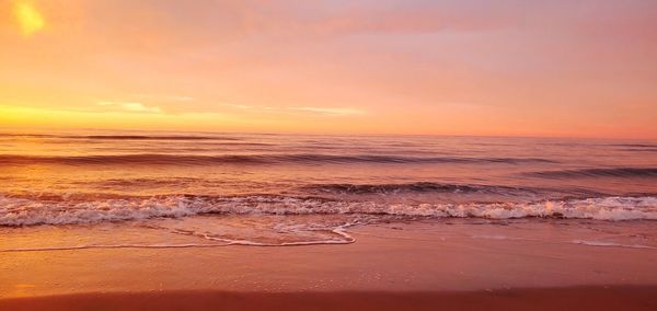 Scenic view of beach against sky during sunset