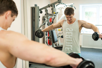 Young man exercising in gym