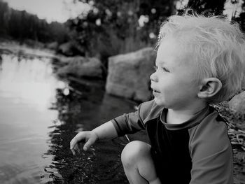 Woman standing on tree trunk
