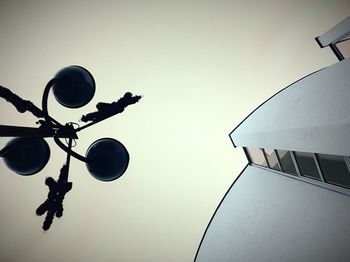 Low angle view of silhouette lamp against sky