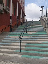 Staircase leading towards building against sky