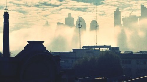 Skyscrapers against cloudy sky