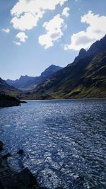 Scenic view of lake and mountains against sky