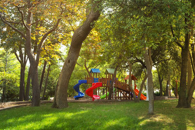 View of playground against trees in park