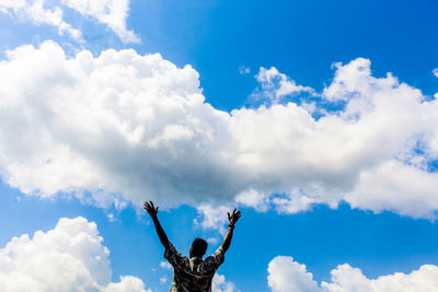 Low angle view of person on tree against sky