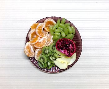 Directly above shot of fruit salad in plate on table