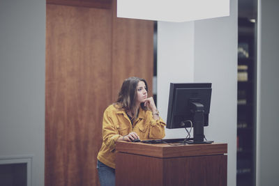 Woman using smart phone on table