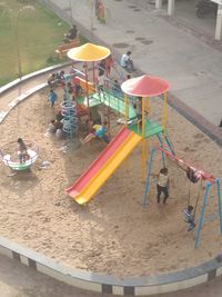 High angle view of deck chairs on sand at playground
