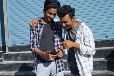 Portrait of young man using mobile phone