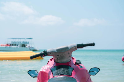 Close-up of boat in sea against sky