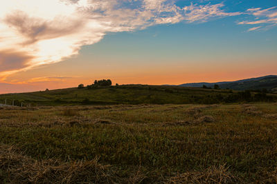 Scenic view of field against sky during sunset