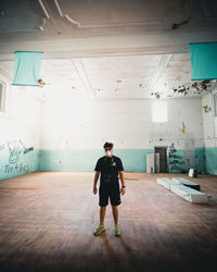 Full length of man standing against wall