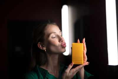 Side view of woman drinking glass