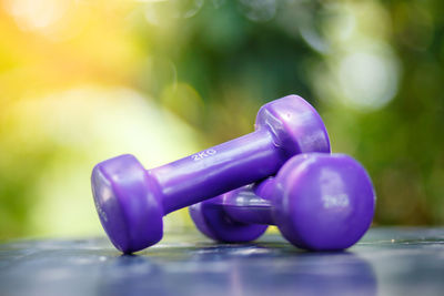 Close-up of purple dumbbells on table