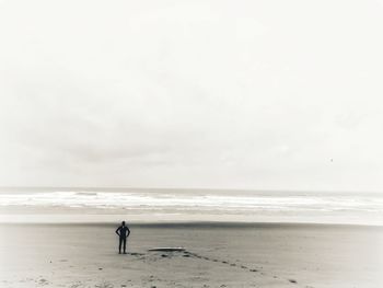 Woman on beach against sky