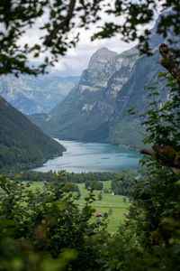 Scenic view of lake and snowcapped mountains against sky