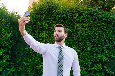 Full length of a young man photographing