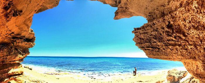 Scenic view of beach against blue sky