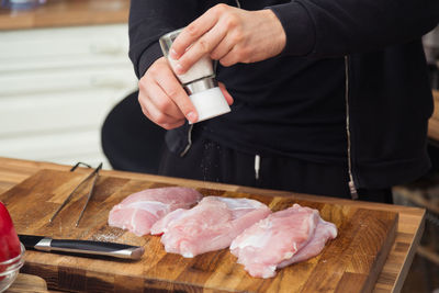 Midsection of man preparing food on table