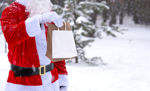 Midsection of woman holding gift