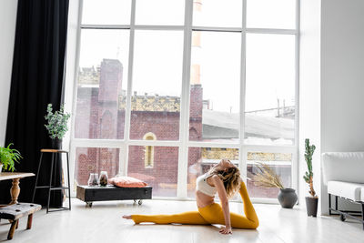 Woman sitting by window at home