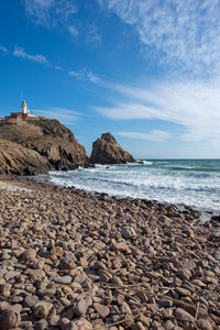 Rocks on beach against sky