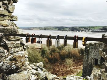 Scenic view of rocks by river against sky