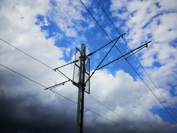 Low angle view of electricity pylon against sky