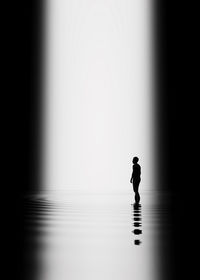 Silhouette man standing in water