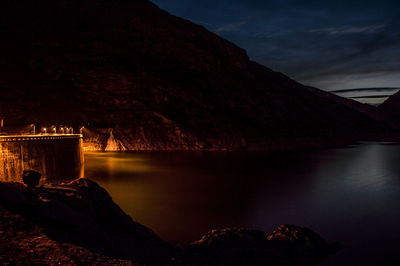 Scenic view of lake against sky at night