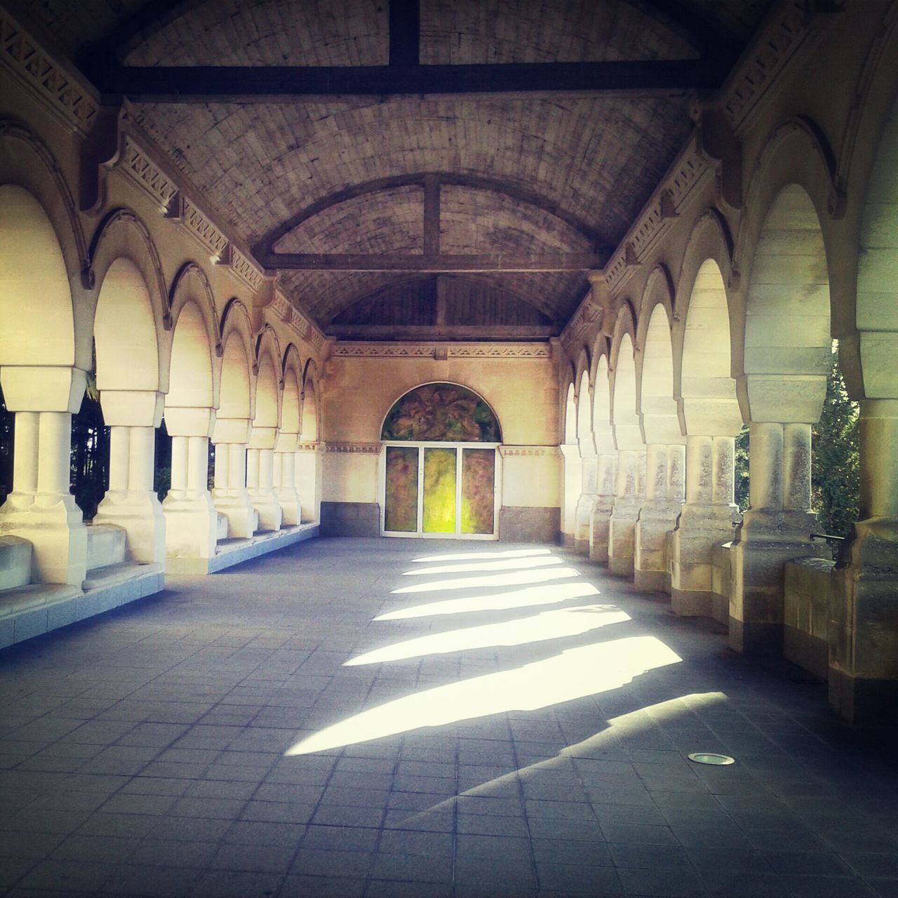 architecture, built structure, corridor, arch, indoors, the way forward, flooring, empty, architectural column, tiled floor, building exterior, ceiling, cobblestone, column, diminishing perspective, building, door, history, walkway, colonnade