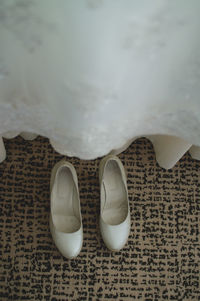 High angle view of white shoes on carpet