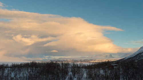 Scenic view of snow covered landscape against sky during sunset