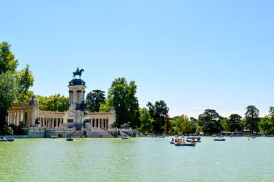 View of boats in water against clear sky