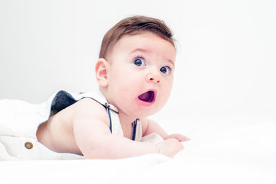 Portrait of cute baby against white background