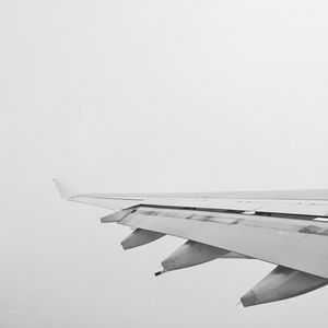 Close-up of airplane wing against clear sky