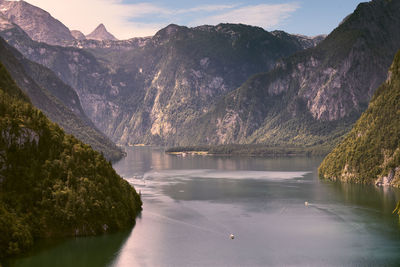 Scenic view of lake by mountains against sky