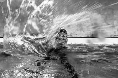 Blurred motion of man splashing water
