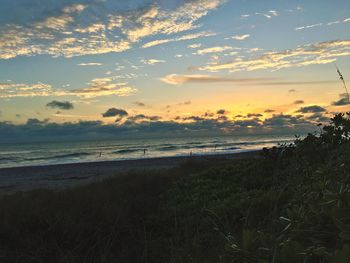 View of beach against cloudy sky