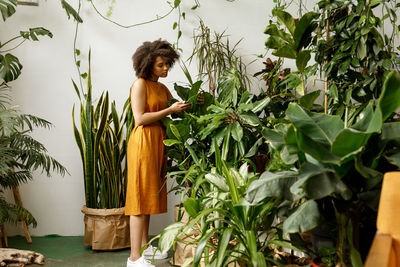 Woman standing by plants