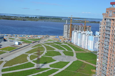 High angle view of buildings by sea against sky