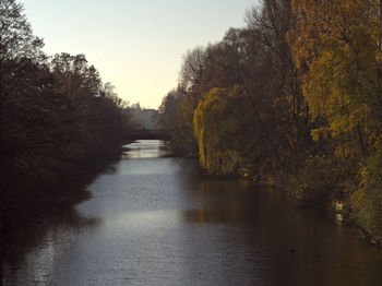 River amidst trees against sky