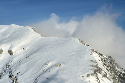Scenic view of snow covered mountains against sky