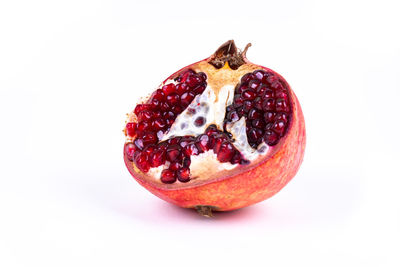 Close-up of strawberry on cake against white background