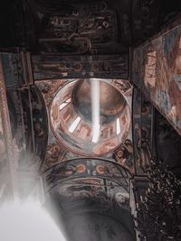 Low angle view of illuminated lamp in building